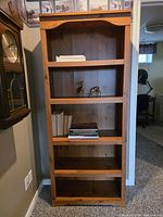 Front view of wooden bookcase with five shelves