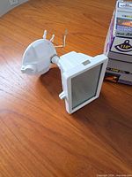 Light fixture showing housing, sensor arm and wiring