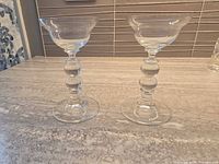 Pair of clear glass candle holders, front view