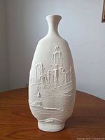 Front view of bisque ceramic vase with Southwestern relief