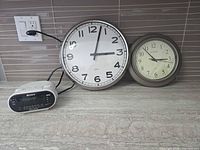 All three clocks on countertop showing scale and style