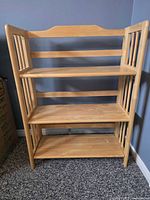 Front view of collapsible wooden 3-shelf bookcase