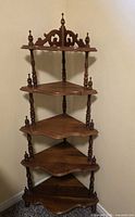 Full view of 5-tier corner shelf standing in corner