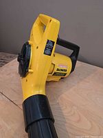 Side view of yellow Paramount blower showing vent cover and handle