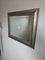 Front view of framed rectangular mirror on wall