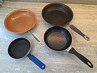 Top view of all four fry pans on countertop