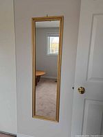 Full view of framed wall mirror mounted on door
