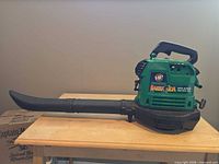 Left side view of green Weed Eater Barracuda gas leaf blower with attached tube