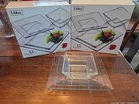 Two Libbey Tempo 12-piece boxed sets with sample plates and bowl displayed