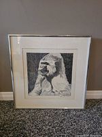 Frontal view of framed gorilla pencil drawing, silver frame, matted