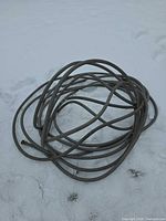 Coiled grey hose on snow
