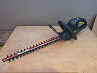 Full side view of hedge trimmer showing complete blade and handles
