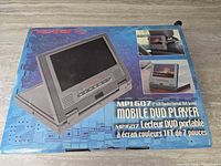 Retail box showing Nextar MP1607 7-inch Mobile DVD Player branding