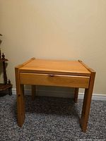 Front view of pine side table showing drawer closed