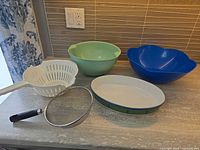 All five kitchen items arranged on countertop