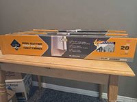 Three boxed Alu-Rex Clip N Guard rain gutter guards on table