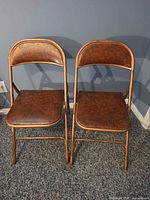 Front view of both folding chairs unfolded on carpet
