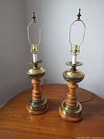 Front view of both matching wood and brass table lamps