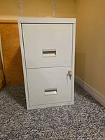 Front view showing two drawers, recessed handles, lock and key