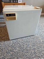 Front view of GE compact bar fridge showing GE badge and handle