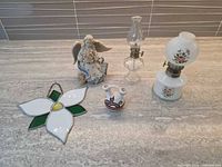 Group shot of figurine, stained glass trillium, two mini oil lamps, mini vase