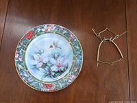 Front view of porcelain collector plate with hanging bracket