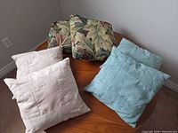 Six throw pillows in three color/pattern sets displayed on table