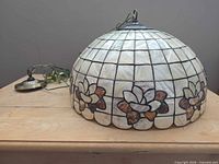 Side view of stained glass dome shade showing floral motif