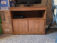 Front view of TV stand showing open shelf and closed lower doors