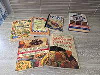All six cookbooks laid out on countertop