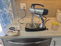 Full view of mixer with bowls, manual, cover and beaters