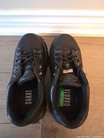 Top view of pair showing laces, brand name on insoles and CSA tags