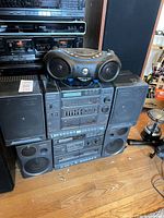 Full view of stacked Panasonic system with speakers and boombox on top