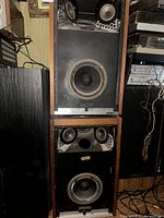 Full view of both Bose 601 Series speakers stacked, showing driver layout and wood cabinets