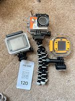 Overview of three action cameras in housings and flexible tripod