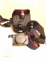 Camera body, neck strap and carrying case overview