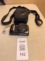 Camera and case overview with MaxSold lot card visible