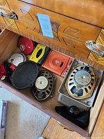 Drawer view with portable players, speaker drivers, grill and tweeter