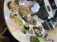 Overhead view of all ten decorative clocks on round table