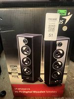 Front of retail box showing speakers and model