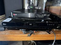 Three stacked disc players showing LG branding and Blu-ray logo