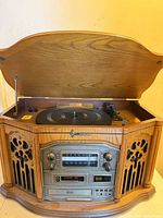 Front view of Emerson wooden stereo system with lid open showing turntable and control panel