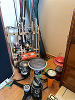 Overall view of rack with rods, reels, camping lanterns and accessories