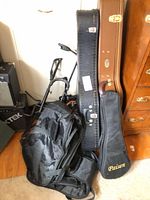 Group view of assorted guitar cases, stand, Paisen soft case