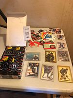 Overview of assorted hockey cards, plastic-sleeved cards, and storage box