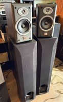 JBL E20 bookshelf speakers atop Polk Audio floorstanding speakers