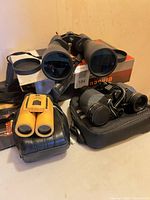 All three binoculars grouped with Magnicon box visible