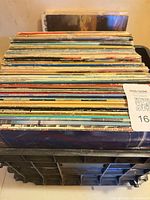 Crate filled with stacked vinyl LP records
