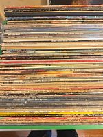 Full stack of vinyl LPs showing quantity