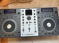 Front view of entire Numark Mixdeck console showing both jog wheels, mixer section and displays